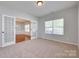 Bright bedroom with neutral carpet and double French doors leading to another room at 1412 Afternoon Sun Rd, Matthews, NC 28104