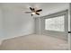 Neutral bedroom with a ceiling fan and a large window for ample natural light at 1412 Afternoon Sun Rd, Matthews, NC 28104