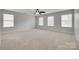 Large bedroom with three windows offering natural light and ceiling fan at 1412 Afternoon Sun Rd, Matthews, NC 28104