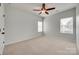 Neutral bedroom with a ceiling fan and windows that provide ample natural light at 1412 Afternoon Sun Rd, Matthews, NC 28104