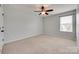Neutral bedroom with a ceiling fan and a window that provides ample light at 1412 Afternoon Sun Rd, Matthews, NC 28104
