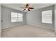 Neutral bedroom with carpet, a ceiling fan, and a window for natural lighting at 1412 Afternoon Sun Rd, Matthews, NC 28104