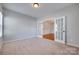 Neutral bedroom with double French doors leading to another room and a large window at 1412 Afternoon Sun Rd, Matthews, NC 28104