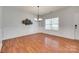 Bright, spacious dining room featuring wainscoting, modern chandelier, and hardwood floors at 1412 Afternoon Sun Rd, Matthews, NC 28104