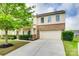 Traditional home with a two-car garage, brick accents, and green landscaping at 1412 Afternoon Sun Rd, Matthews, NC 28104