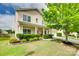 Inviting two-story home with a well-manicured lawn and charming covered front porch at 1412 Afternoon Sun Rd, Matthews, NC 28104
