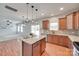 Kitchen showcasing granite countertops, an island, stainless steel appliances, and hardwood floors at 1412 Afternoon Sun Rd, Matthews, NC 28104