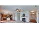 Spacious living room with a fireplace, ceiling fan, and view of the adjacent kitchen at 1412 Afternoon Sun Rd, Matthews, NC 28104