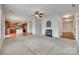 Spacious living room featuring a fireplace, a ceiling fan, neutral walls, and an open floor plan at 1412 Afternoon Sun Rd, Matthews, NC 28104