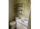 Modest bathroom featuring a vanity, toilet, and metal shelving at 1418 Old Wilkesboro Rd, Salisbury, NC 28144