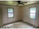 A simple bedroom with two windows and patterned floors at 1418 Old Wilkesboro Rd, Salisbury, NC 28144
