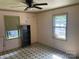 A cozy bedroom featuring tile-patterned flooring and window with natural light at 1418 Old Wilkesboro Rd, Salisbury, NC 28144
