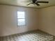 A simple bedroom with a single window and patterned tile floors at 1418 Old Wilkesboro Rd, Salisbury, NC 28144