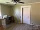 A cozy bedroom featuring laminate wood flooring and a ceiling fan at 1418 Old Wilkesboro Rd, Salisbury, NC 28144