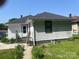 Charming single-story home featuring white siding, dark shingle roof, and quaint front entry at 1418 Old Wilkesboro Rd, Salisbury, NC 28144