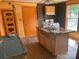 Kitchen area featuring wood countertops, an island sink and an orange door at 1418 Old Wilkesboro Rd, Salisbury, NC 28144