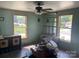 Sunlit living room with dual windows, ceiling fan and decorative trim at 1418 Old Wilkesboro Rd, Salisbury, NC 28144