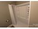 Shower with white tile and toiletry shelves providing both style and convenience to this lovely home at 1421 Thompson Ave, Charlotte, NC 28216
