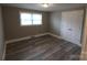 Cozy bedroom features wood-look floors and a double door closet at 1421 Thompson Ave, Charlotte, NC 28216