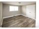 This bedroom features wood-look flooring and a double door closet at 1421 Thompson Ave, Charlotte, NC 28216