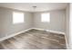 Spacious bedroom featuring natural light and wood look flooring at 1421 Thompson Ave, Charlotte, NC 28216