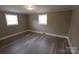 Well lit room with two windows, modern flooring and neutral paint at 1421 Thompson Ave, Charlotte, NC 28216