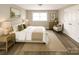 Serene bedroom featuring soft natural light, a comfortable bed, and ample closet space at 1421 Thompson Ave, Charlotte, NC 28216
