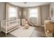 Cozy Bedroom with a crib, soft rug, neutral tones, and natural light from two windows at 1421 Thompson Ave, Charlotte, NC 28216