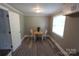 Cozy dining area boasts new floors, neutral paint, and a window for natural light at 1421 Thompson Ave, Charlotte, NC 28216