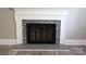 Modern fireplace with stone surround and white mantle at 1421 Thompson Ave, Charlotte, NC 28216
