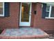Front door with glass and dark shutters on a brick facade at 1421 Thompson Ave, Charlotte, NC 28216