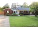 Charming brick ranch with landscaped front yard at 1421 Thompson Ave, Charlotte, NC 28216