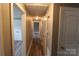 Light-filled hallway with wood-look floors, closet, and paneled doors at 1421 Thompson Ave, Charlotte, NC 28216