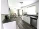 Updated kitchen features stainless steel appliances, gray countertops, and sleek white cabinets at 1421 Thompson Ave, Charlotte, NC 28216
