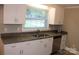 Bright and updated kitchen with new cabinets, granite countertops, and a stainless-steel sink at 1421 Thompson Ave, Charlotte, NC 28216