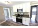 Updated kitchen features stainless steel appliances, gray countertops, and sleek white cabinets at 1421 Thompson Ave, Charlotte, NC 28216