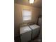 Laundry room with a window and white washer and dryer at 1421 Thompson Ave, Charlotte, NC 28216
