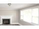 Bright living room with fireplace and large windows at 1421 Thompson Ave, Charlotte, NC 28216