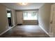 Bright living room with large window and new floors perfect for relaxing or entertaining guests at 1421 Thompson Ave, Charlotte, NC 28216