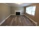 Bright living room with fireplace, large window, and modern floors at 1421 Thompson Ave, Charlotte, NC 28216
