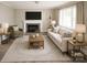Inviting living room featuring comfortable seating, a fireplace, and ample natural light, creating a warm and inviting space at 1421 Thompson Ave, Charlotte, NC 28216