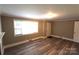 Spacious living room with a large window and modern floors at 1421 Thompson Ave, Charlotte, NC 28216