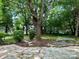 Landscaped backyard patio featuring a beautiful stone arrangement and ample green space at 14211 Harlequin Dr, Charlotte, NC 28273