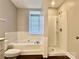 Well-lit bathroom featuring a separate tub and shower with white tile and modern fixtures at 14211 Harlequin Dr, Charlotte, NC 28273