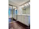 Bright bathroom featuring a double vanity, framed sliding door closet, and separate tub at 14211 Harlequin Dr, Charlotte, NC 28273