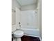 Bathroom featuring a tub and toilet with tile at 14211 Harlequin Dr, Charlotte, NC 28273
