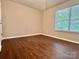 Bedroom with hardwood floors and natural light from the window at 14211 Harlequin Dr, Charlotte, NC 28273