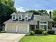 Charming home featuring a two-car garage and landscaped front yard at 14211 Harlequin Dr, Charlotte, NC 28273