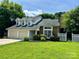 Charming home featuring a two-car garage and landscaped front yard at 14211 Harlequin Dr, Charlotte, NC 28273