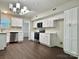 Bright, updated kitchen featuring ample white cabinetry, stainless steel appliances, and modern lighting at 14211 Harlequin Dr, Charlotte, NC 28273